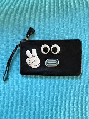 Anya Hindmarch black zip wristlet pouch with eyes and peace hand